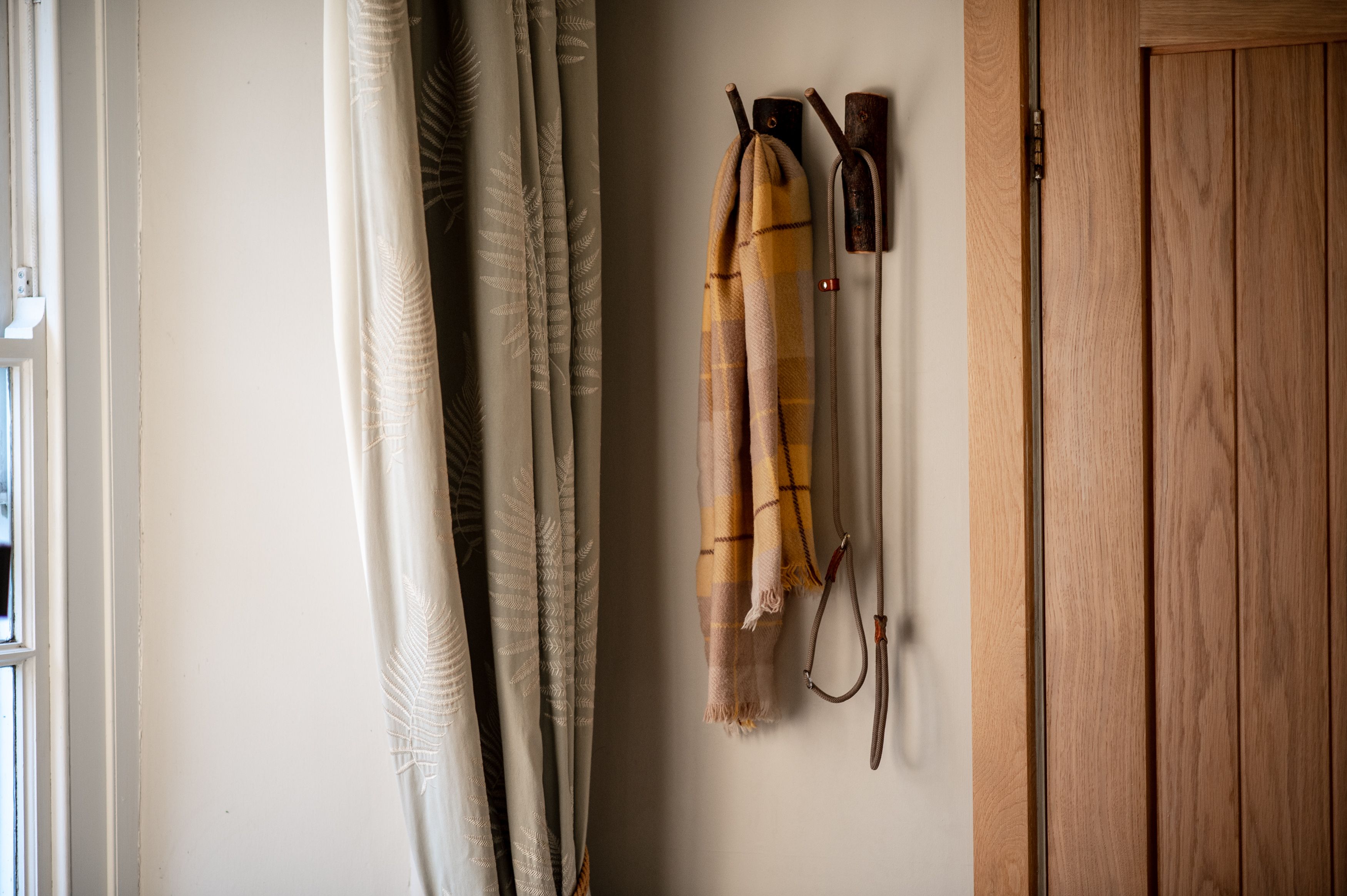 Coat pegs with scarf and lead