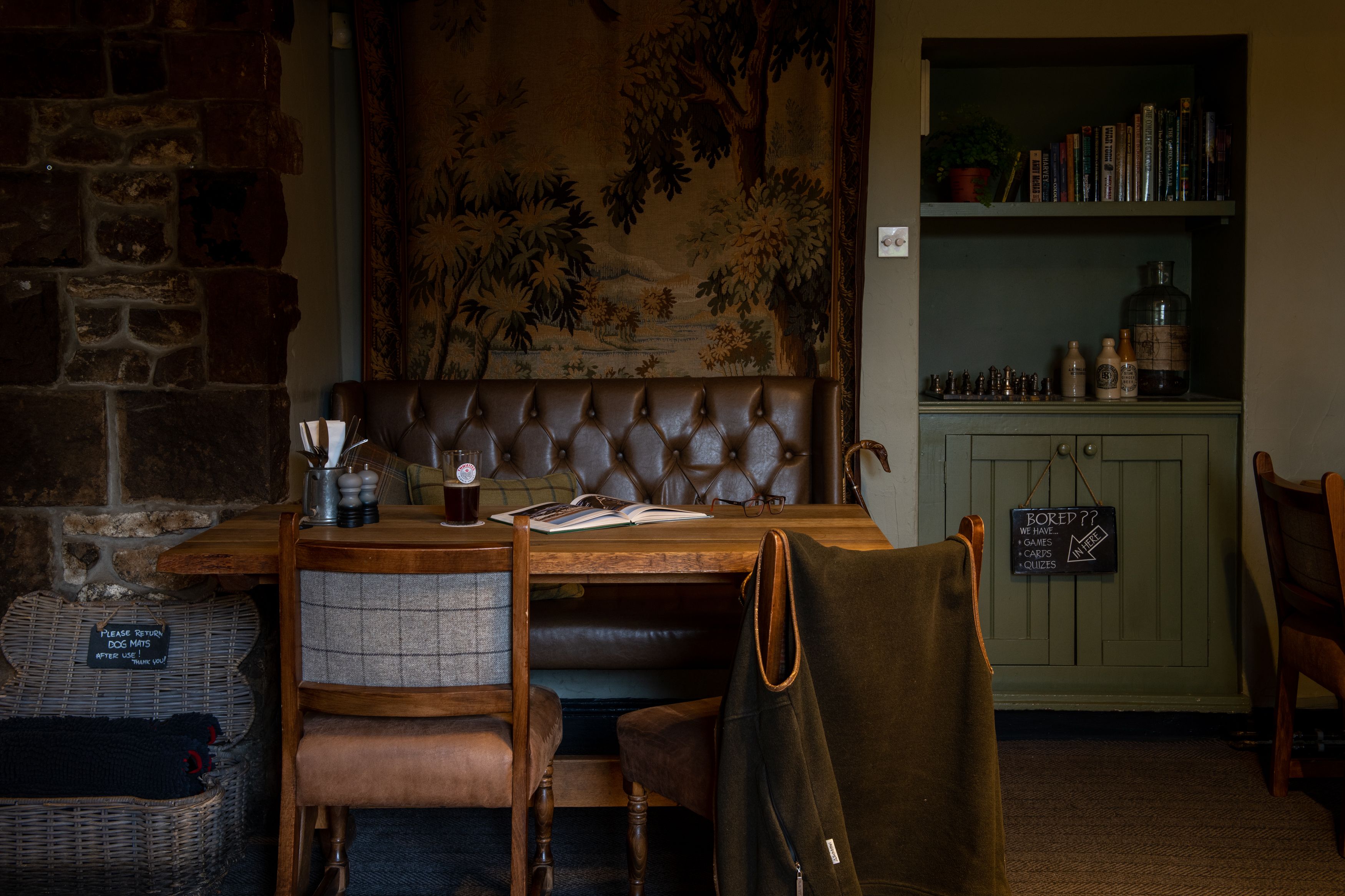 table in restaurant with pint of thwaites