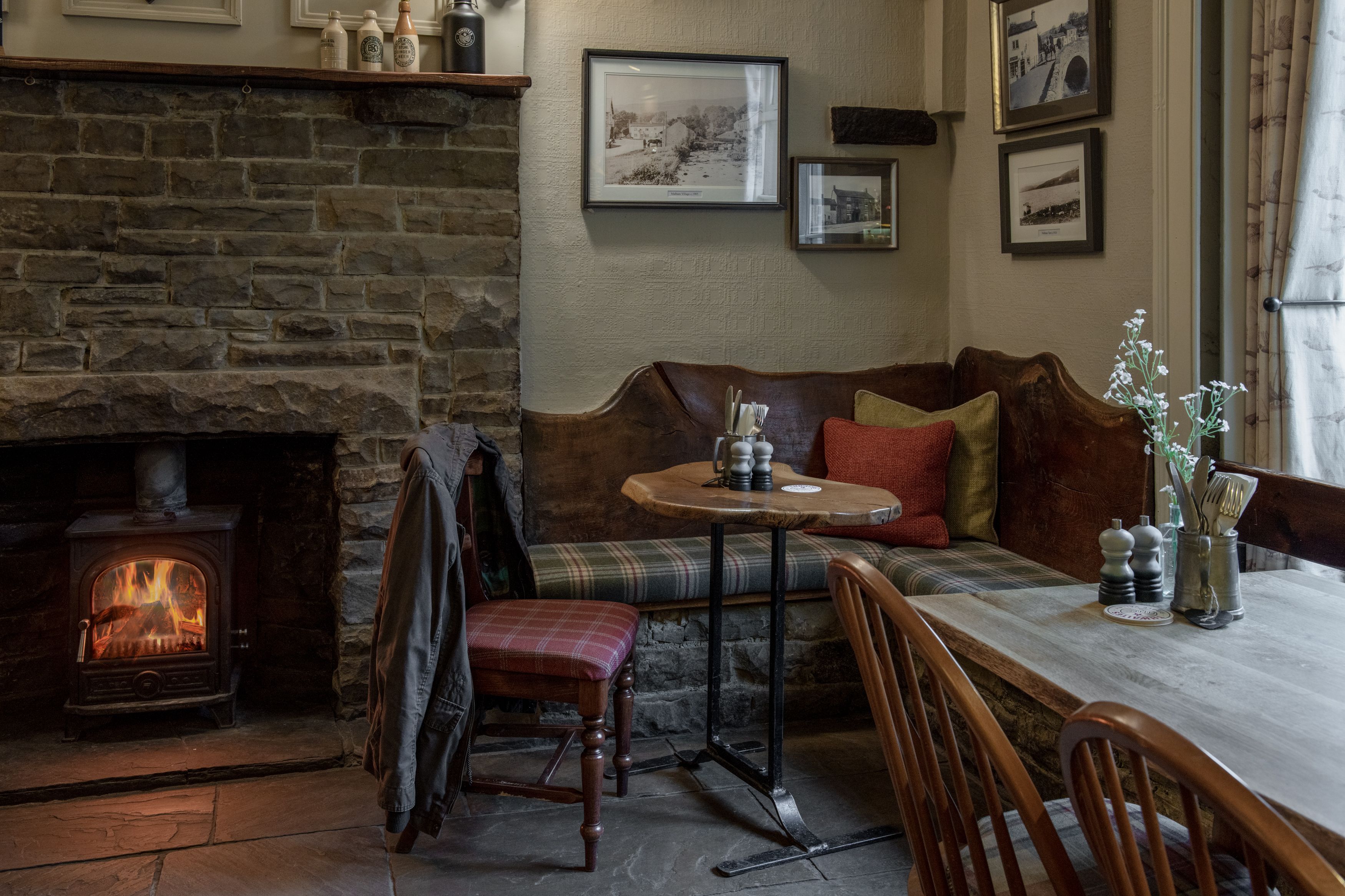 chair with coat hanging on the back in front of fire