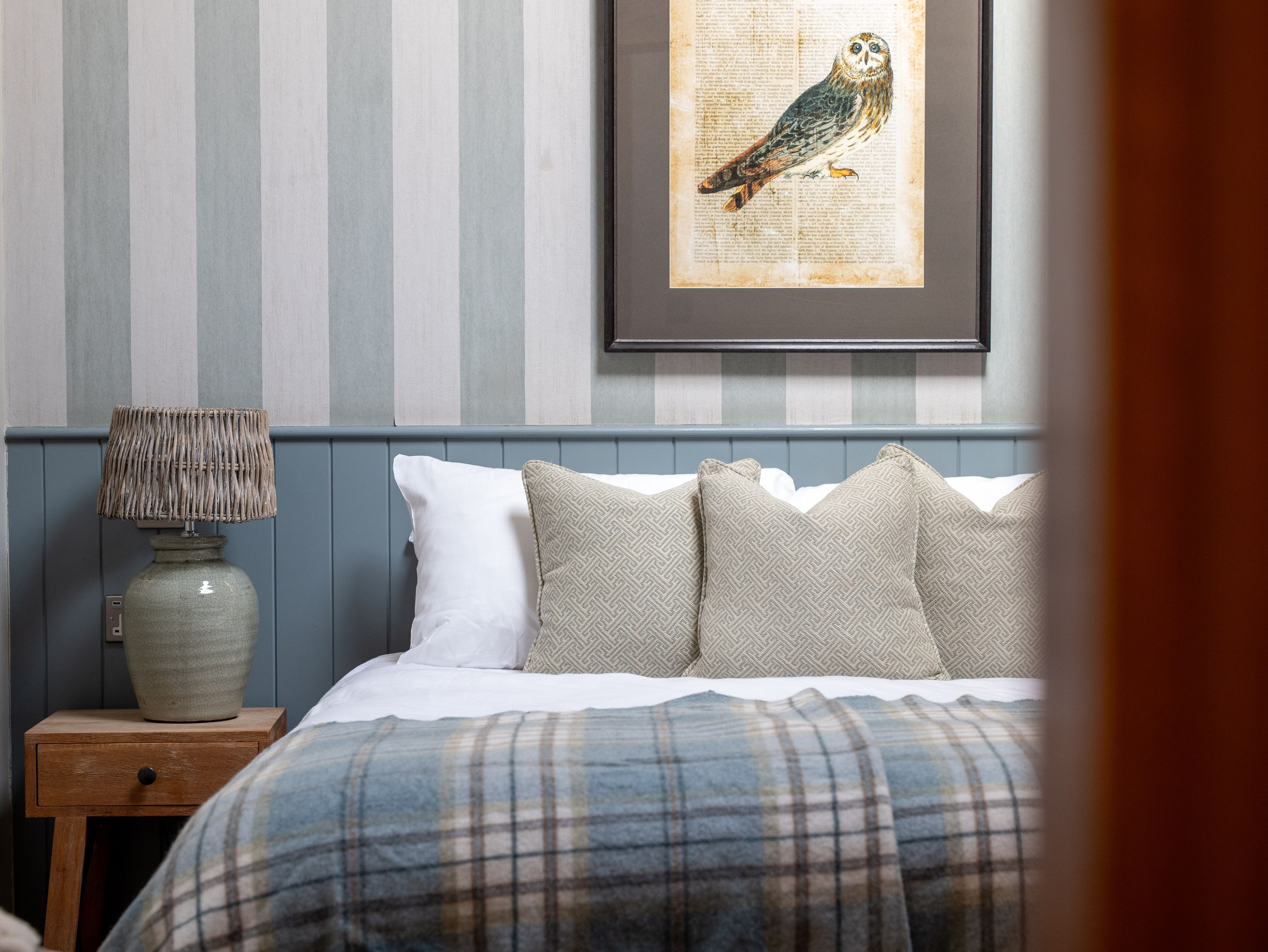 Feature room bed with blue checked throw