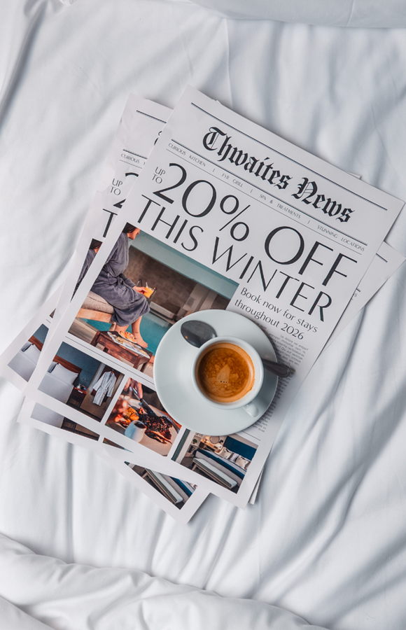 "up to 20% off this winter" newspaper with coffee on a hotel bed