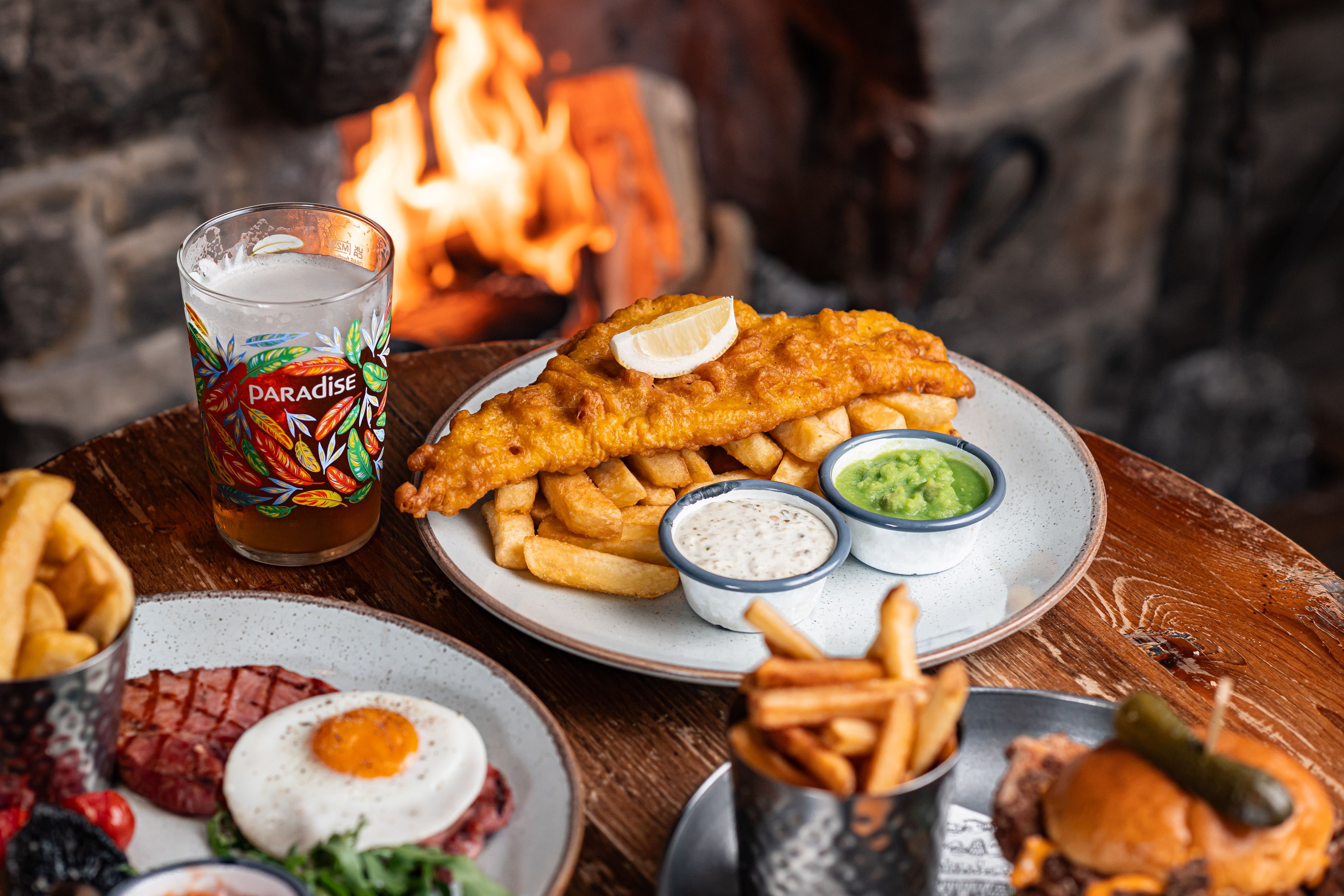 three dishes with fish and chips, gammon steak and chips, and chicken burger